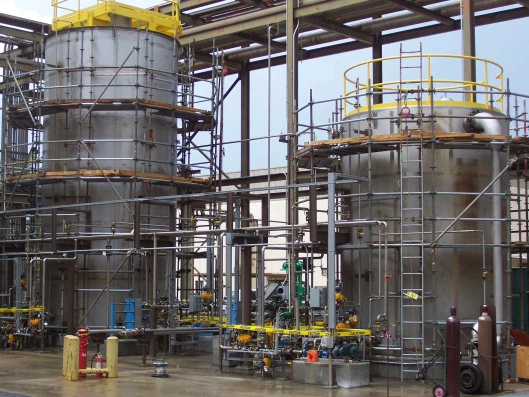 Industrial tanks with scaffolding and piping system.